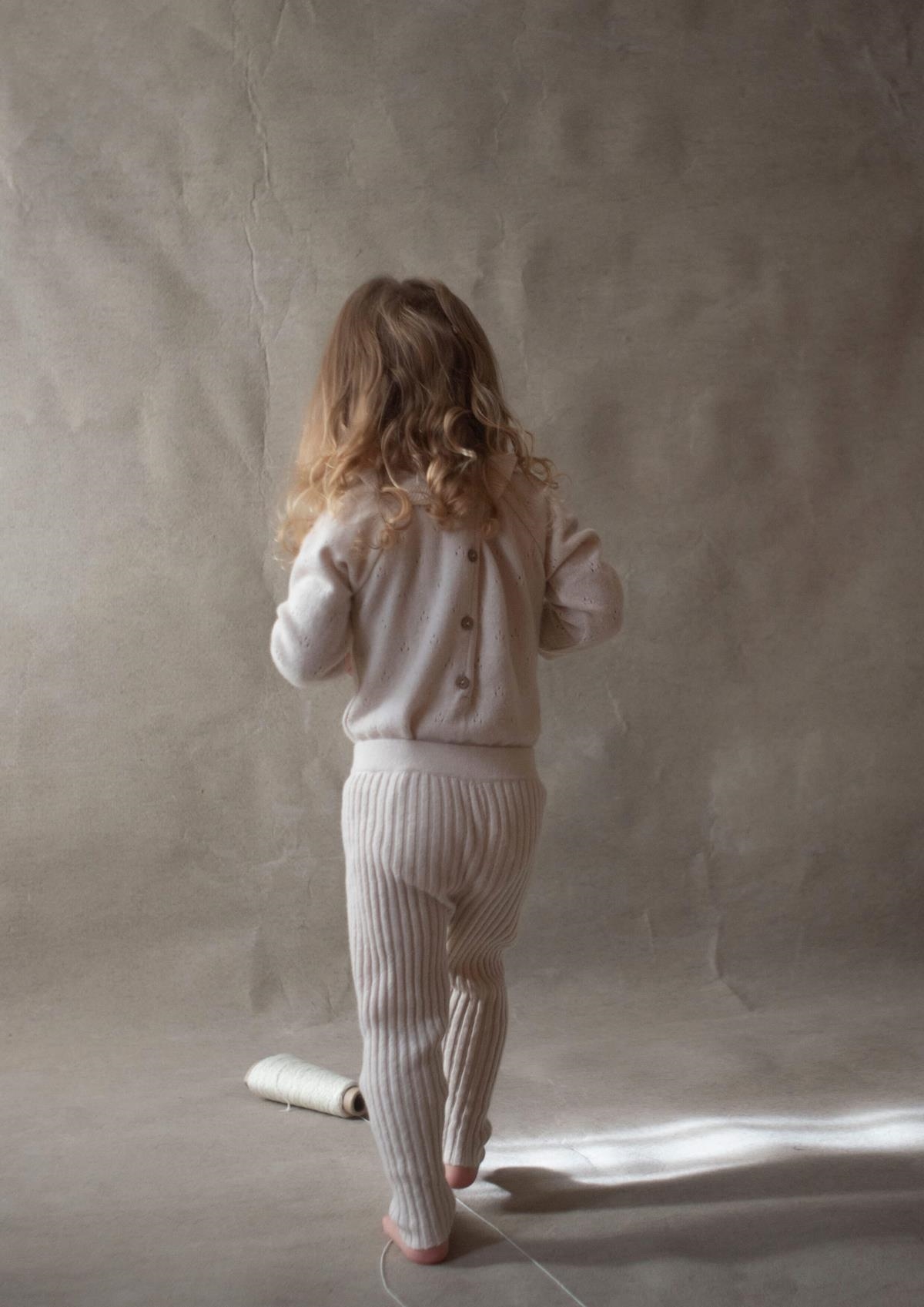 Mod.5.1 Off-white knitted romper suit with frilled collar | AW23.24 Mod.5.1 Off-white knitted romper suit with frilled collar