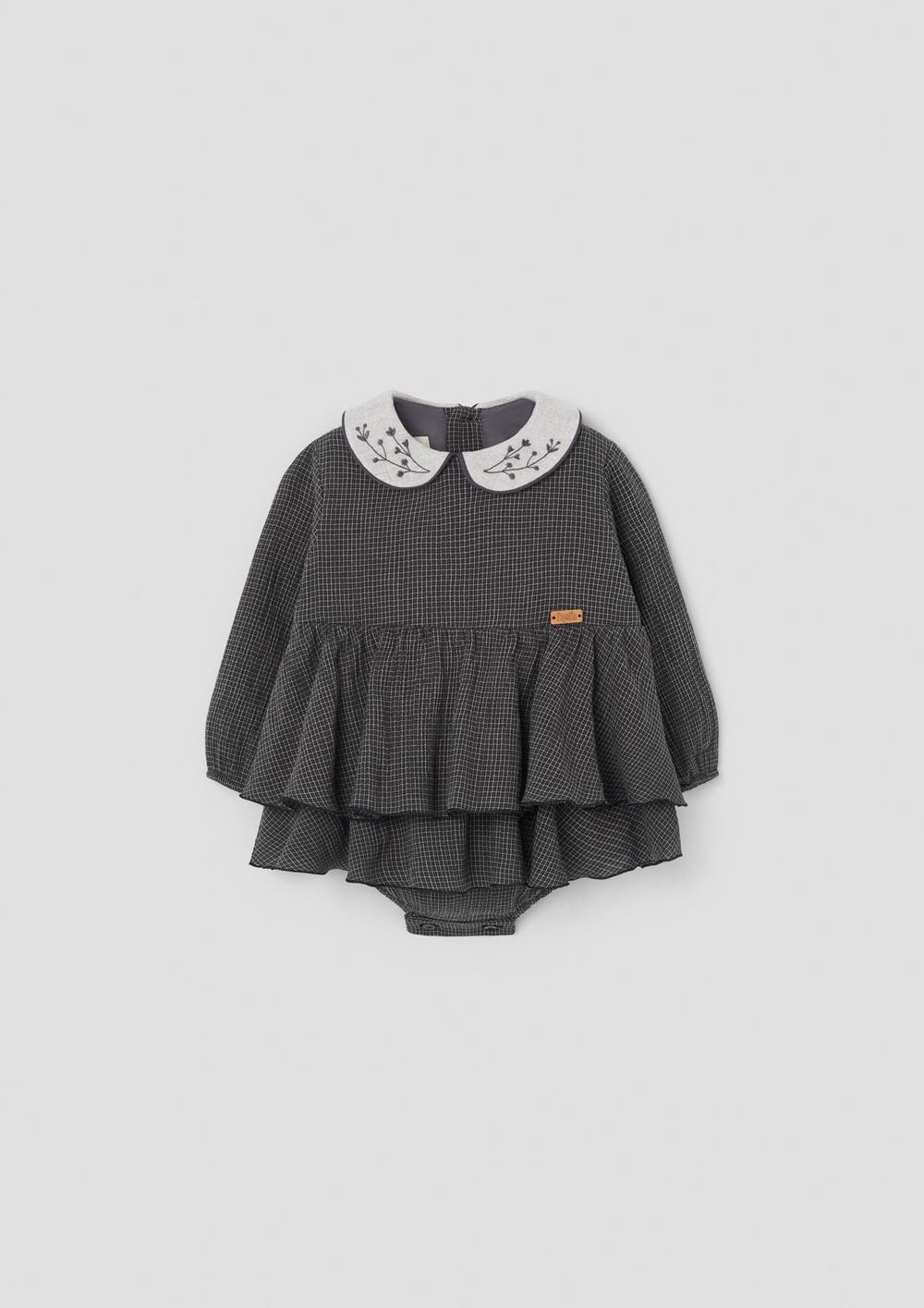 Mod.3.4 Black gingham romper suit with double layer skirt and embroidered baby collar | AW26.27 Mod.3.4 Black gingham romper suit with double layer skirt and embroidered baby collar